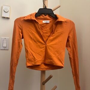 Cropped Babaton Women's Contour V-neck Polo Longsleeve Top in Orange